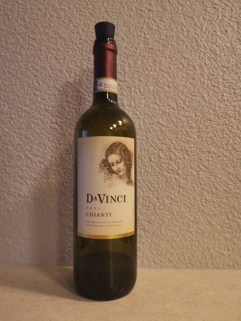 Dimly lit photo of a wine bottle. Label says Da Vinci.