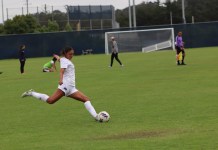 CSUMB Women’s Soccer leaves it all out on the field Soccer player dressed in all white setting up to kick the ball.