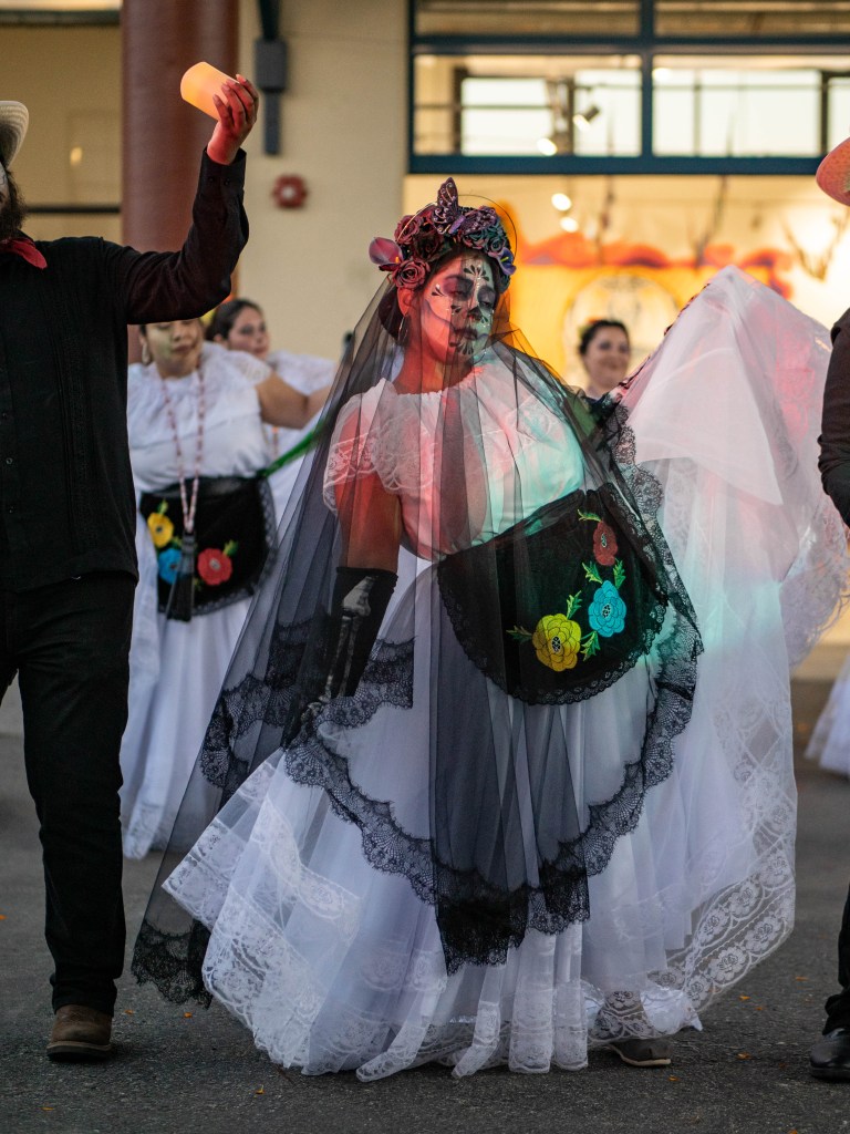 Folklorico dancers performing in white dresses. 