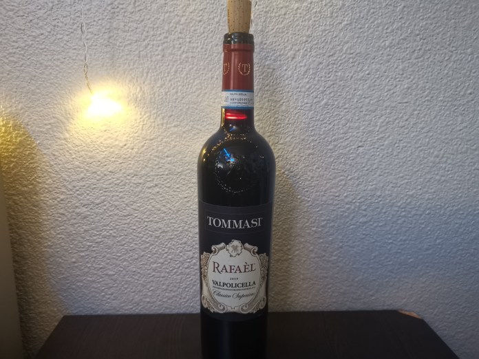 Wine bottle in a dimly lit room with string lights in the background