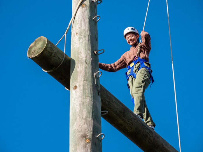 Person walking a high ropes course
