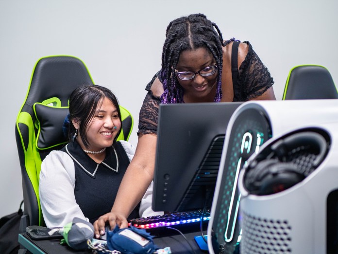 Two students at a gaming computer