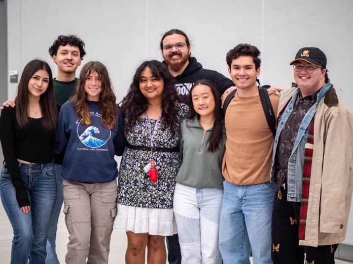Group of 8 students involved with AS gathered for a photo.