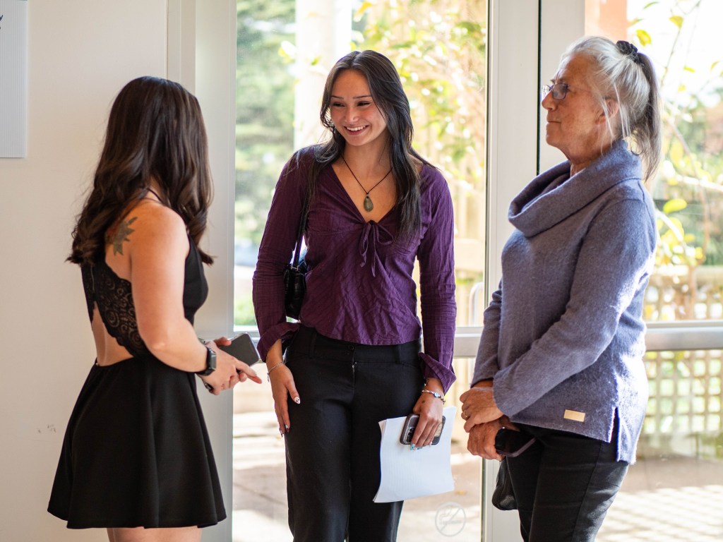 Three attendees talking.