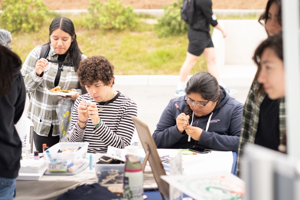 Image of students making Arts and Crafts at a table.