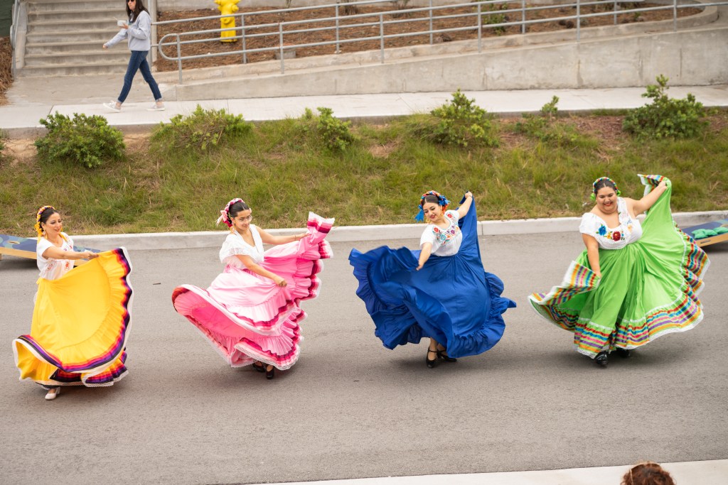 Image of 4 dancers dancing in the OSU quad.