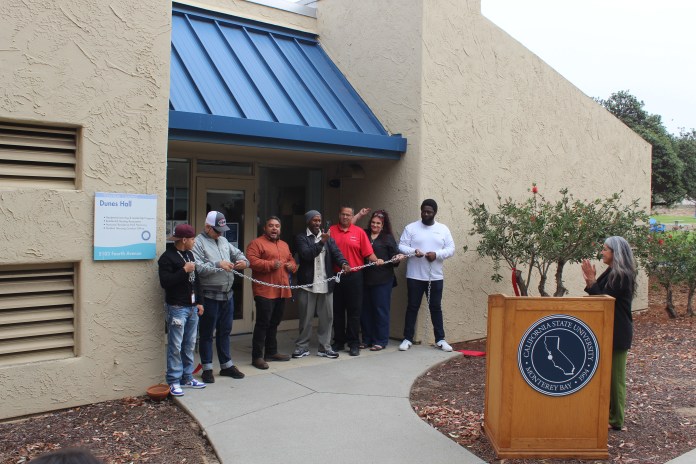 Picture of the Project Rebound staff lined up in front of their new building ready to 