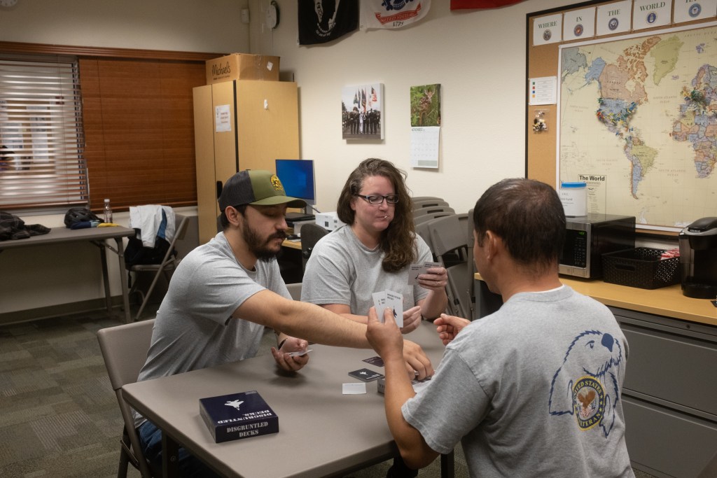 picture of three people from the Veterans Resource Center playing cards at a table