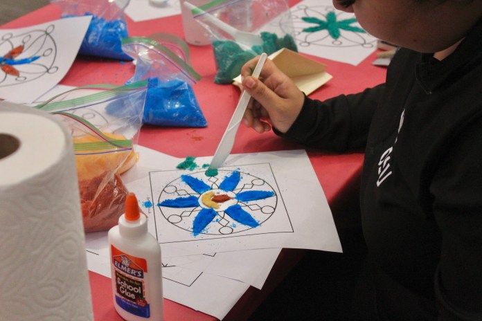 Picture of a student creating a Rangoli