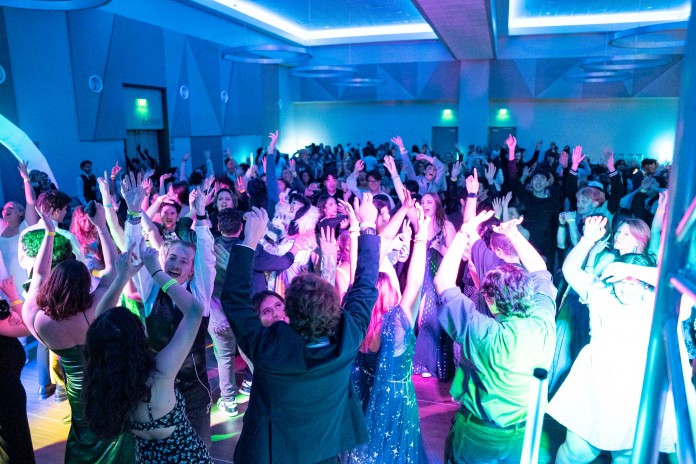 picture of a big crowd with their hands in the air dancing