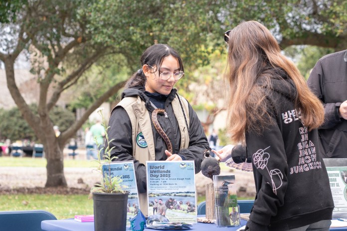 Photo of a event worker speaking with an attendee