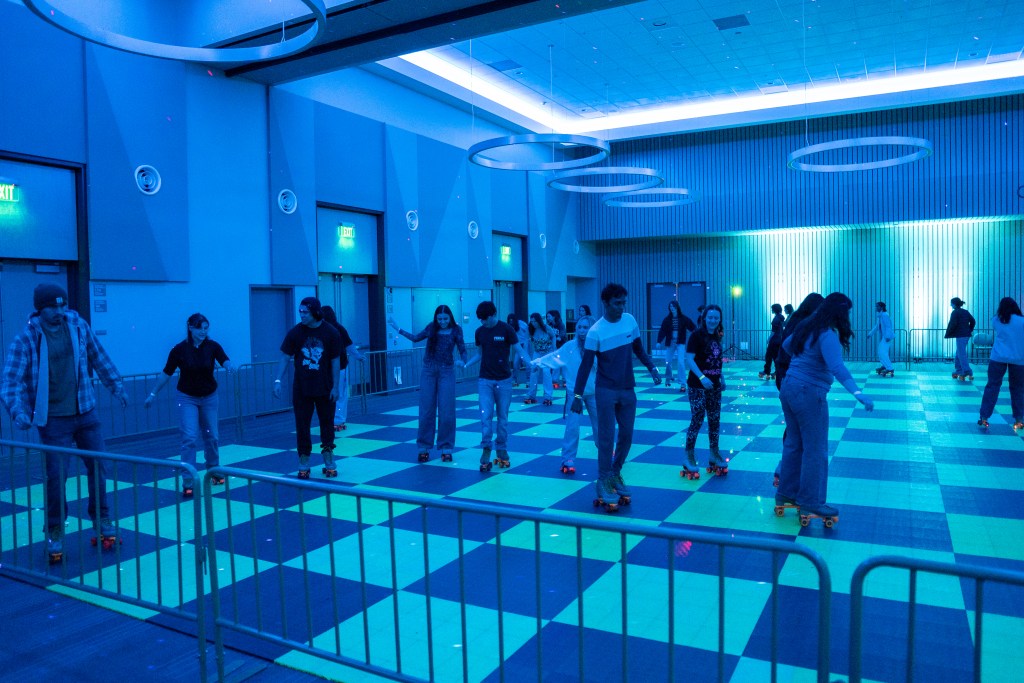 Picture of the roller rink with students skating around.