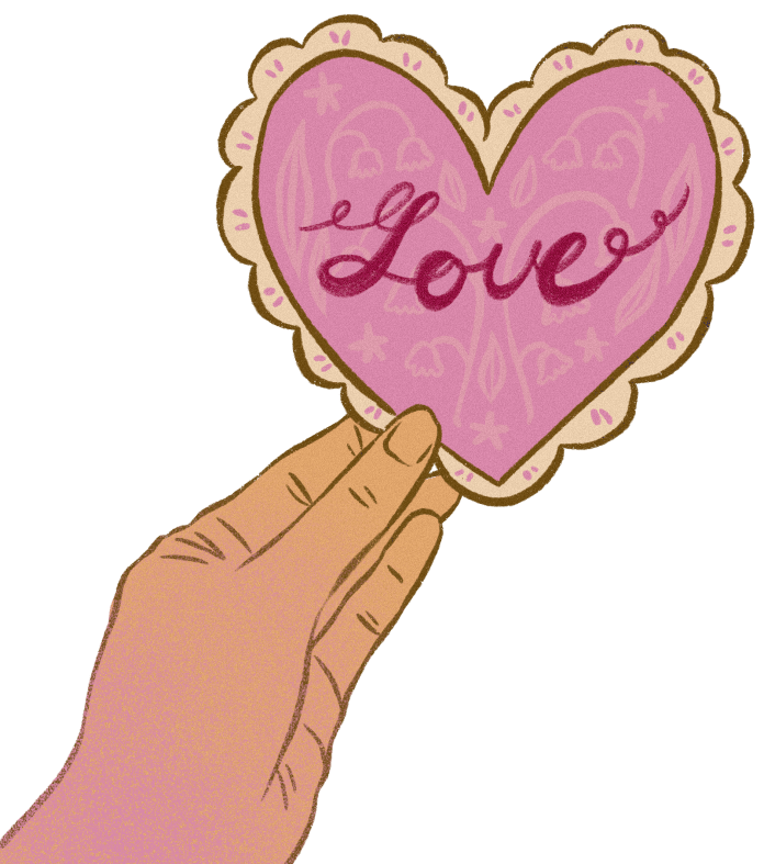 Picture of someone holding a heart shaped cookie that has the text 