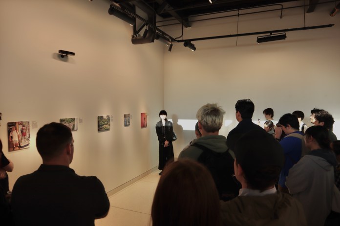 Picture of a student posing next to her art