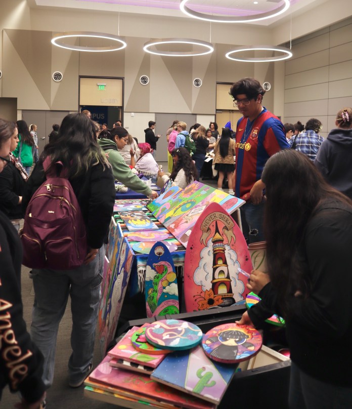 picture of a vendor selling art to people